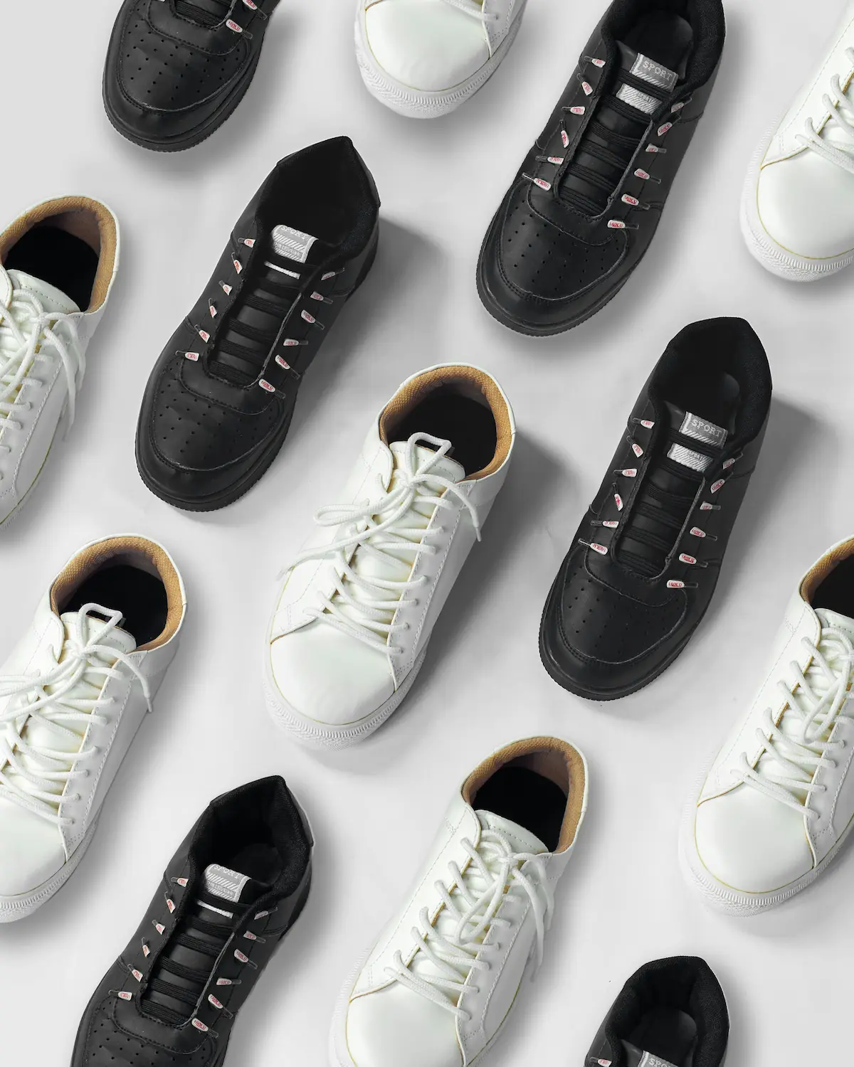 Curated collection of premium white and black leather sneakers displayed in an organized flat lay, representing archival-grade luxury sneaker preservation