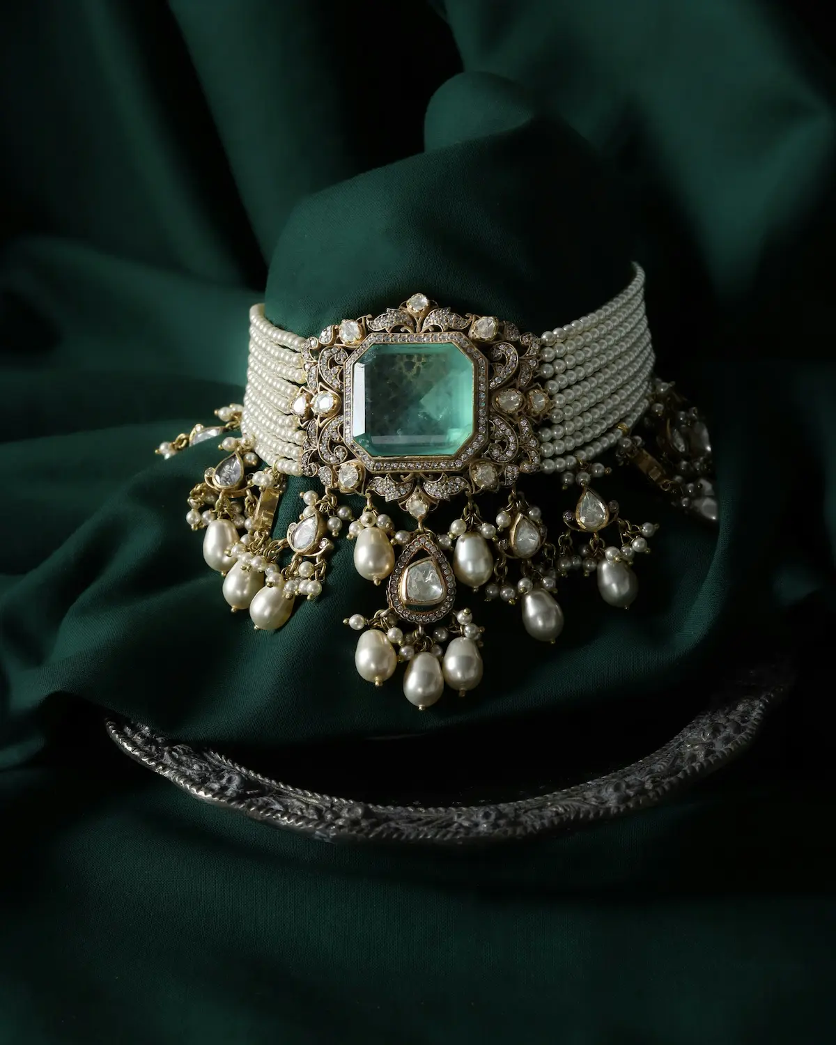 Magnificent antique choker necklace featuring a large emerald centerstone surrounded by diamonds and natural pearls, representing the rare gemstone collections requiring archival-grade conservation protocols