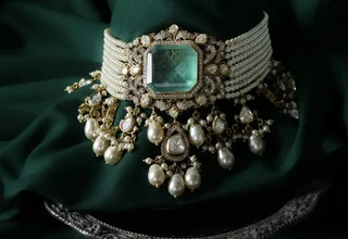 Magnificent antique choker necklace featuring a large emerald centerstone surrounded by diamonds and natural pearls, representing the rare gemstone collections requiring archival-grade conservation protocols