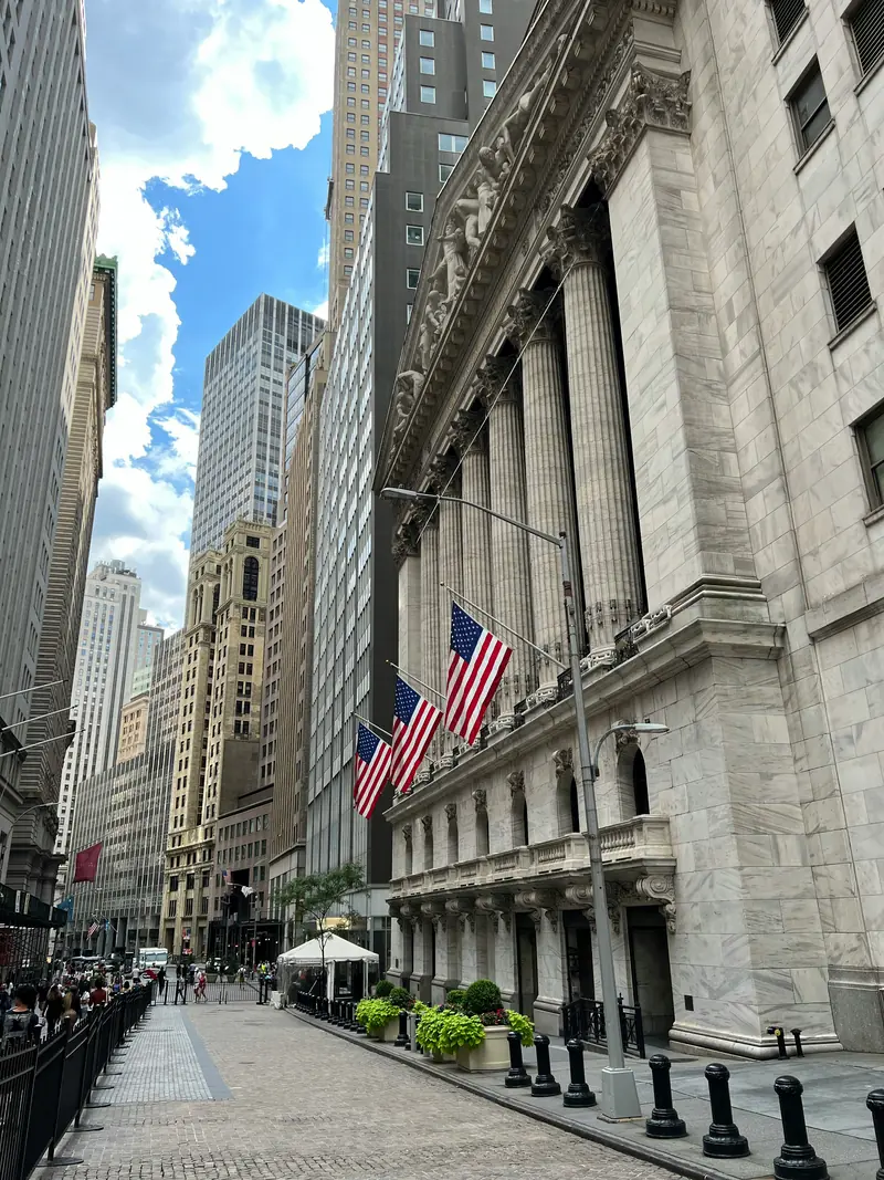 The iconic New York Stock Exchange building on Wall Street, representing the financial markets where luxury goods ETFs like GLUX and LUXX are traded by sophisticated investors