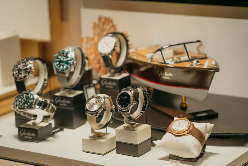 Multiple luxury watches on display stands showing variety of investment-grade timepieces