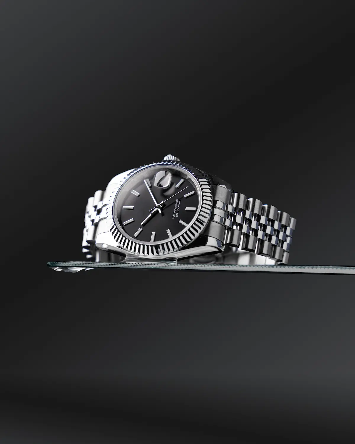 Rolex-style stainless steel watch with jubilee bracelet showing surfaces to clean at home safely