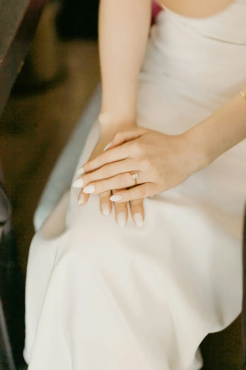 Woman wearing diamond solitaire ring representing a valuable jewelry piece requiring certified appraisal for insurance or estate purposes