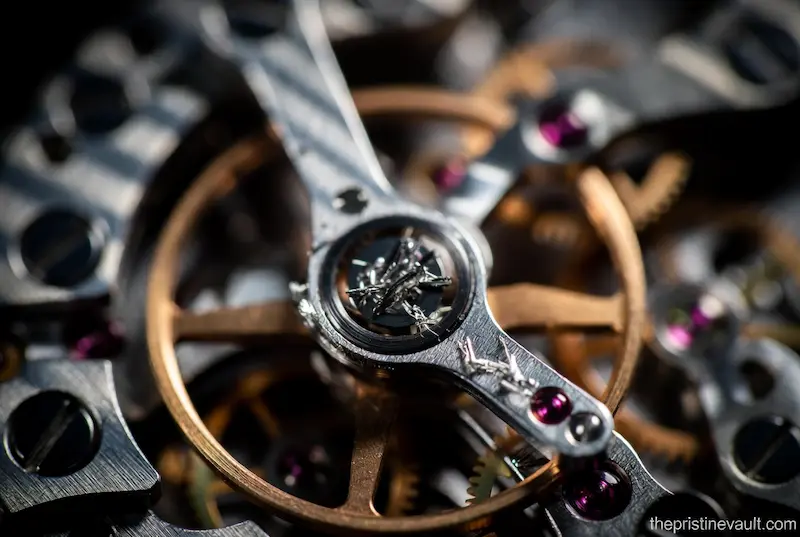 Extreme close-up of dry gears and jewels in a watch movement that needs lubrication and cleaning