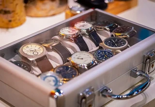 Luxury automatic watch stored in premium wooden watch box with cushion representing proper watch winder storage solution for Rolex Datejust