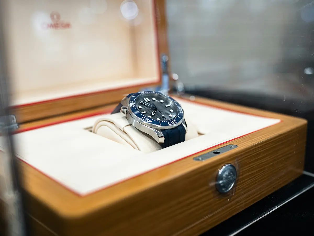 Omega automatic watch stored in premium wooden box representing proper watch winder care for Omega Speedmaster Moonwatch