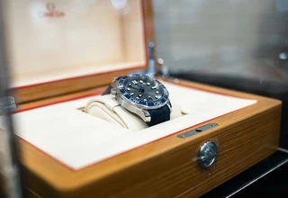 Omega automatic watch stored in premium wooden box representing proper watch winder care for Omega Speedmaster Moonwatch