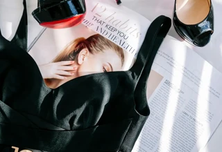 Christian Louboutin black patent heels showing iconic red sole requiring proper storage to protect investment value