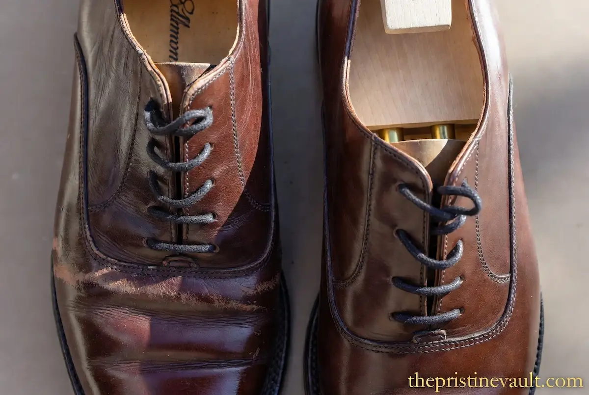 Side-by-side comparison of two Allen Edmonds leather shoes: the left shoe shows leather creasing without support, while the right shoe is perfectly preserved using a cedar wood shoe tree.