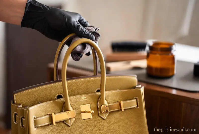 Professional cleaning process using the best leather conditioner for an Hermès Birkin bag to maintain its Togo leather texture and gold hardware shine.