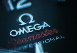 Close-up of an Omega Seamaster watch dial with dark moody lighting