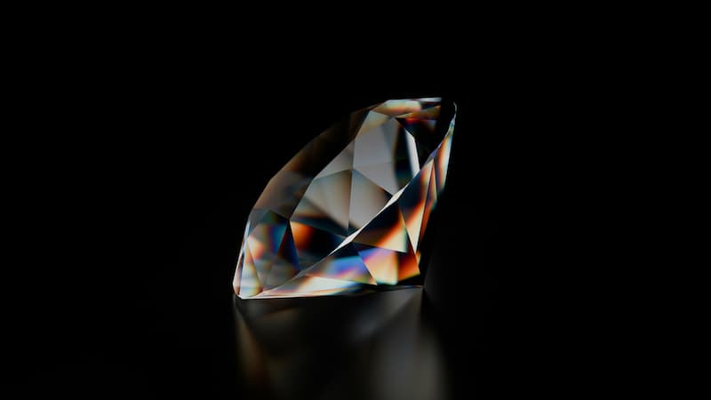 A clear diamond with colorful light refractions on a dark background, showcasing the brilliance of diamond jewelry
