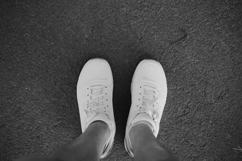 white leather tennis shoes worn luxury sneaker care