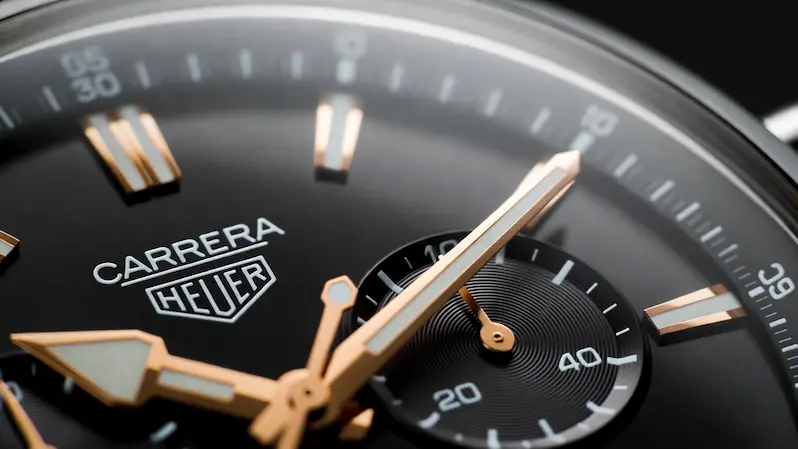 Anatomy of a Luxury Watch: a detailed shot displaying the complex dial of a Heuer Carrera, demonstrating the beauty and value of high-end timepieces