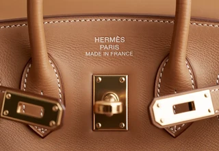 Close-up of authentic Hermès Birkin bag for sale showing the interior foil stamp and saddle stitching for authenticity verification.